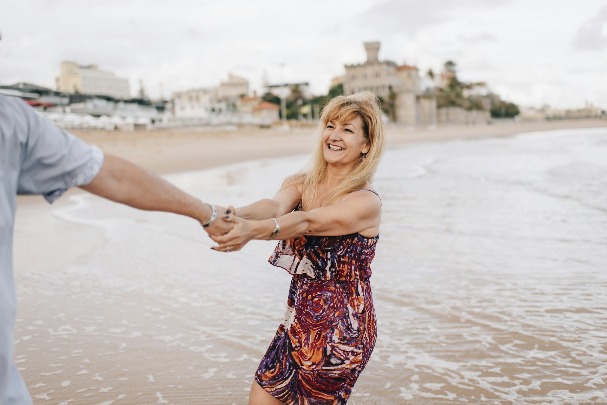 Couple having fun on beach, Estoril, Lisboa, Portugal
