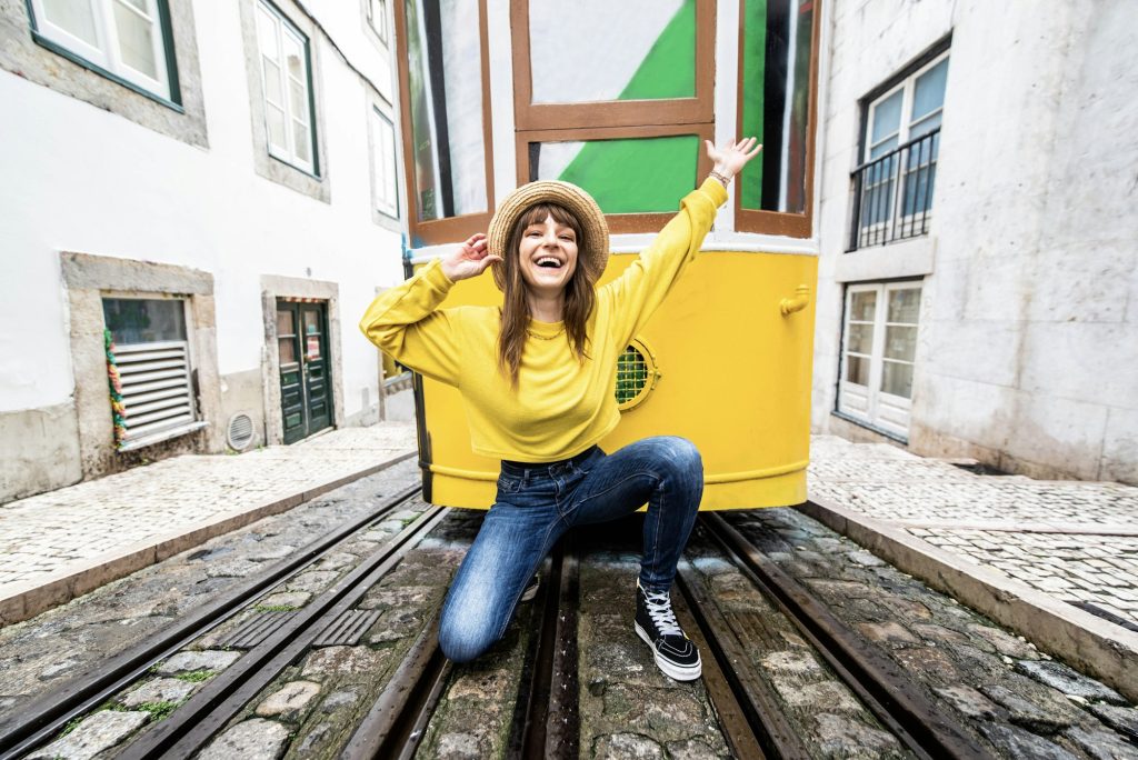 Woman tourist with famous yellow funicular tram of Lisbon, Portugal