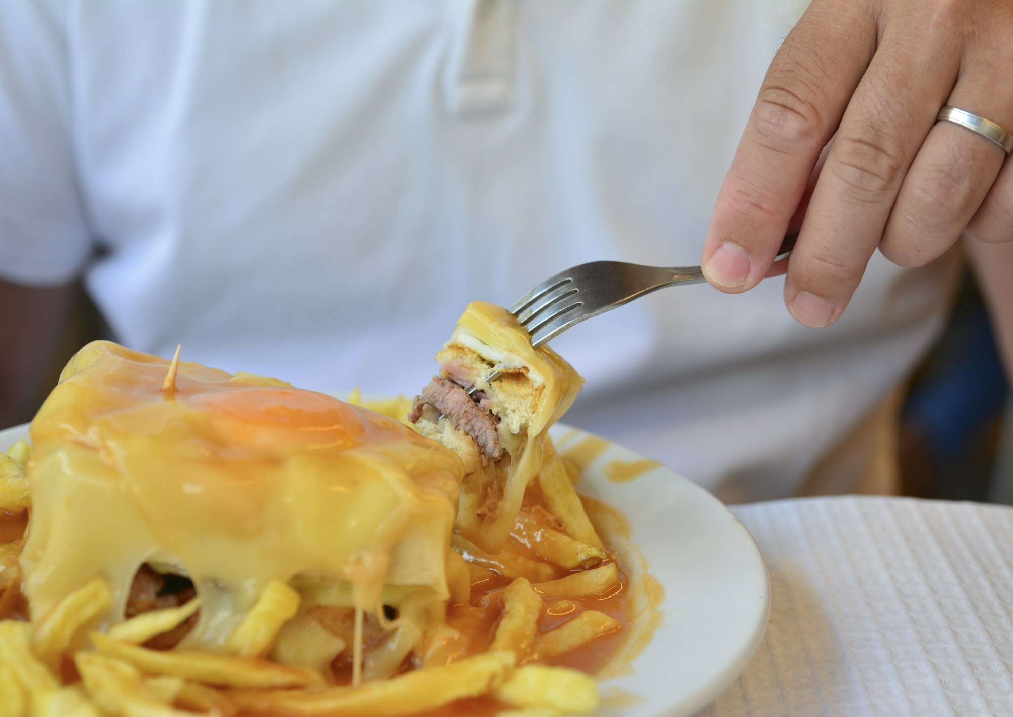 A portuguese sandwich Francesinha served with french fries original dish at Porto, Portugal