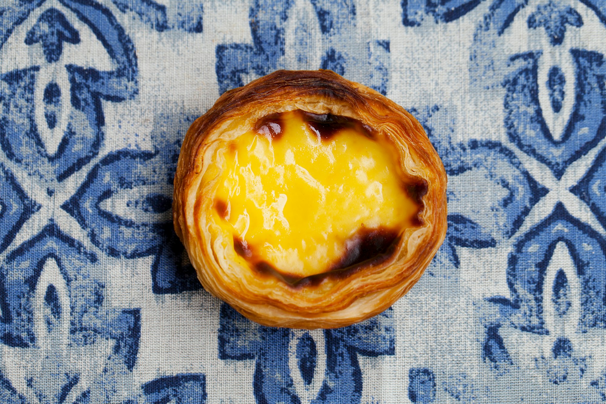 Egg Tart, Traditional Portuguese Dessert, Pastel de Nata. Blue.